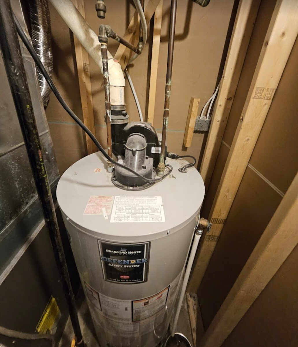 Bradford White Defender 40 gallon natural gas hot water tank installation in Ajax Ontario basement by licensed plumber and HVAC contractor